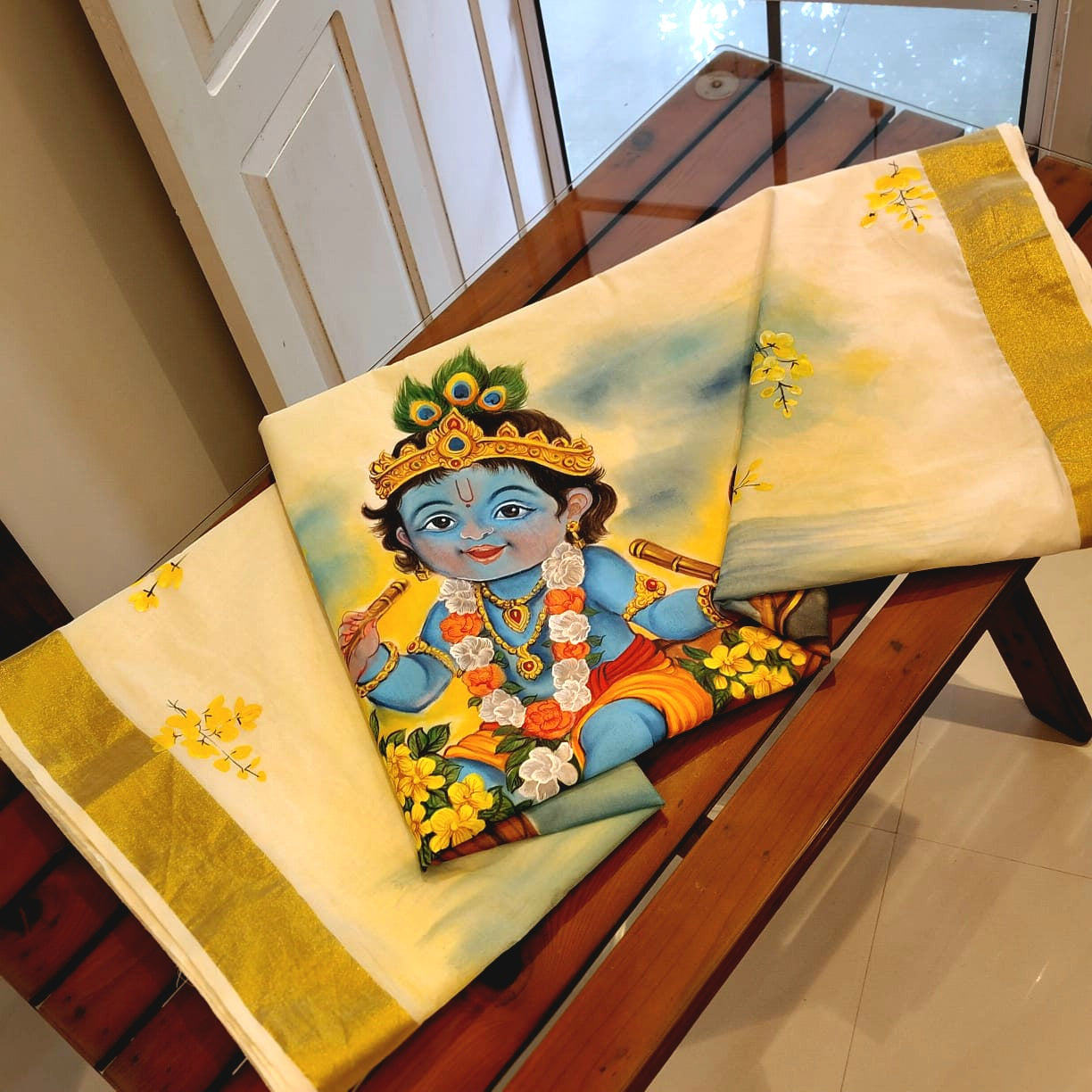 Traditional Kerala Kasavu Saree With A Beautifully Hand-Painted Baby Krishna Motif.