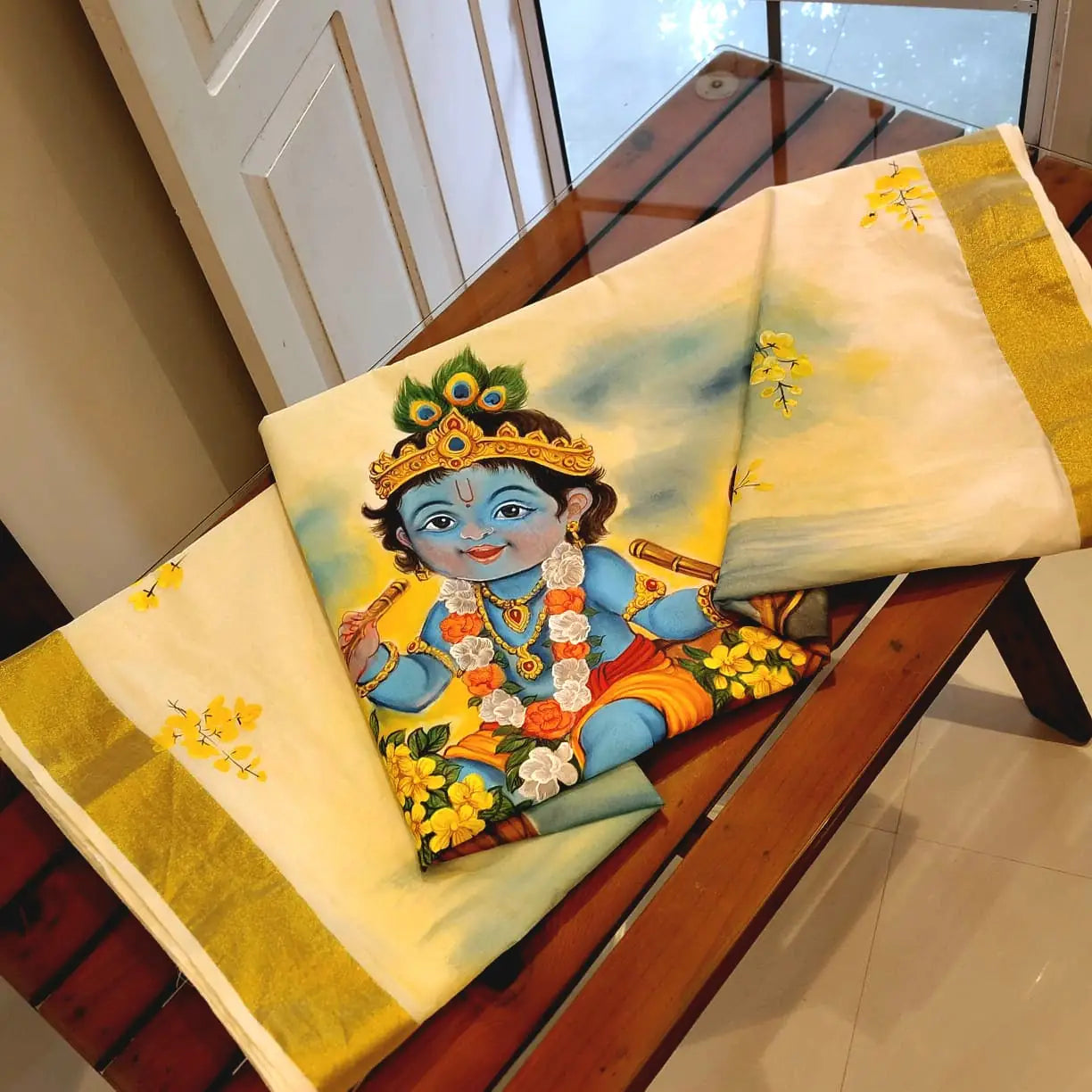 Traditional Kerala Kasavu Saree With A Beautifully Hand-Painted Baby Krishna Motif.