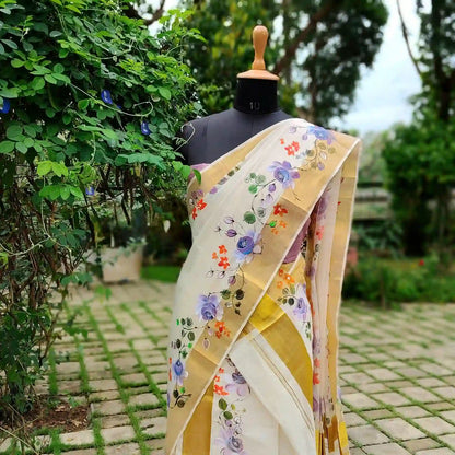 This Kasavu Set Mundu Blooms With The Charm Of Hand-Painted Wild Roses.