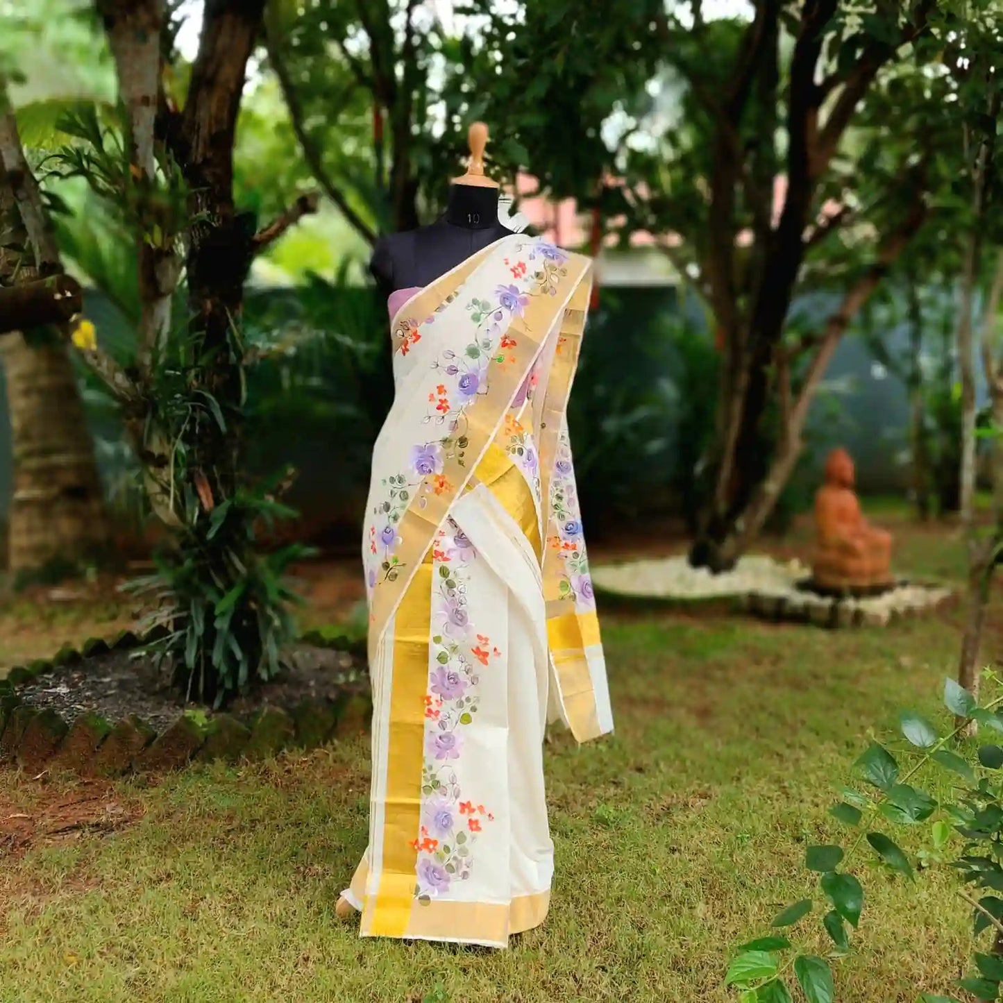 This Kasavu Set Mundu Blooms With The Charm Of Hand-Painted Wild Roses.