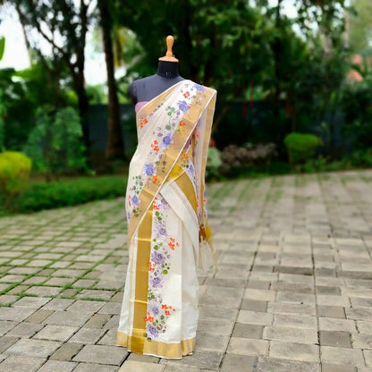 This Kasavu Set Mundu Blooms With The Charm Of Hand-Painted Wild Roses.