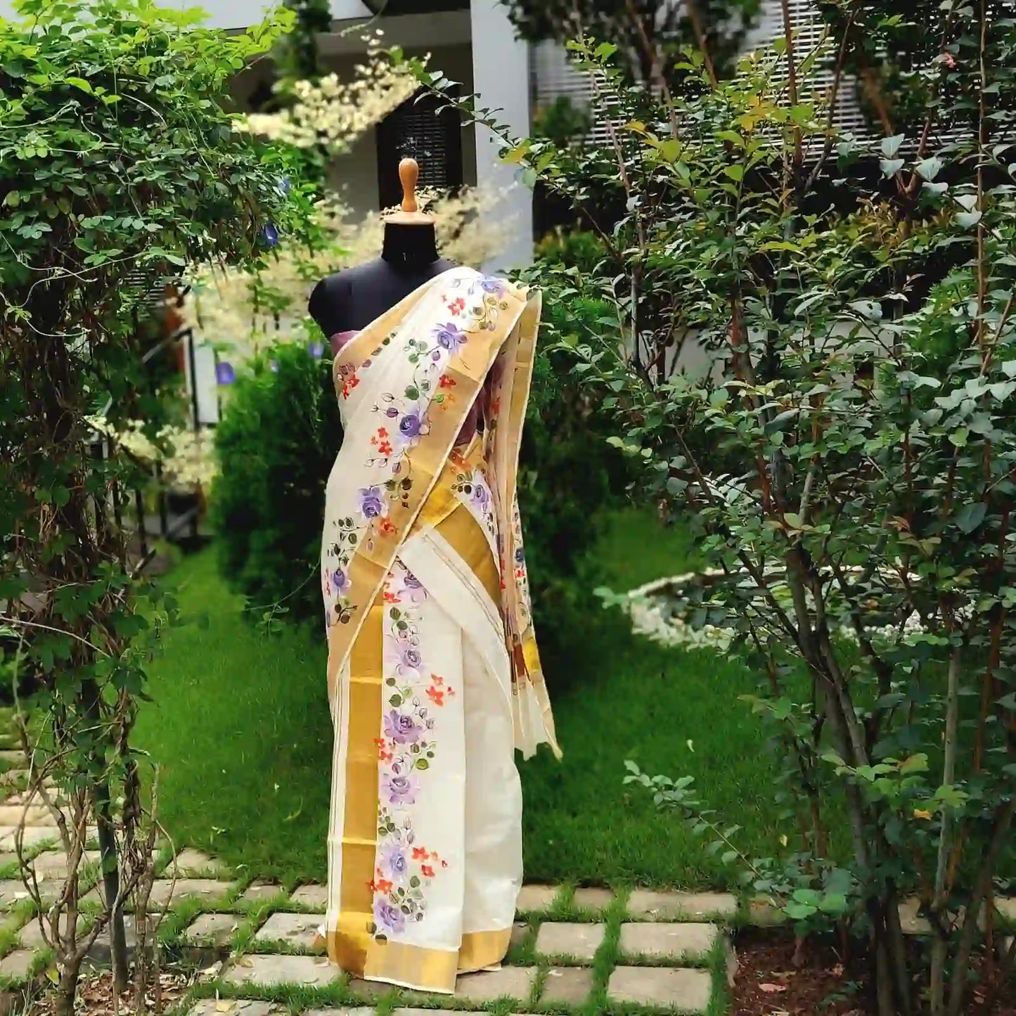 This Kasavu Set Mundu Blooms With The Charm Of Hand-Painted Wild Roses.